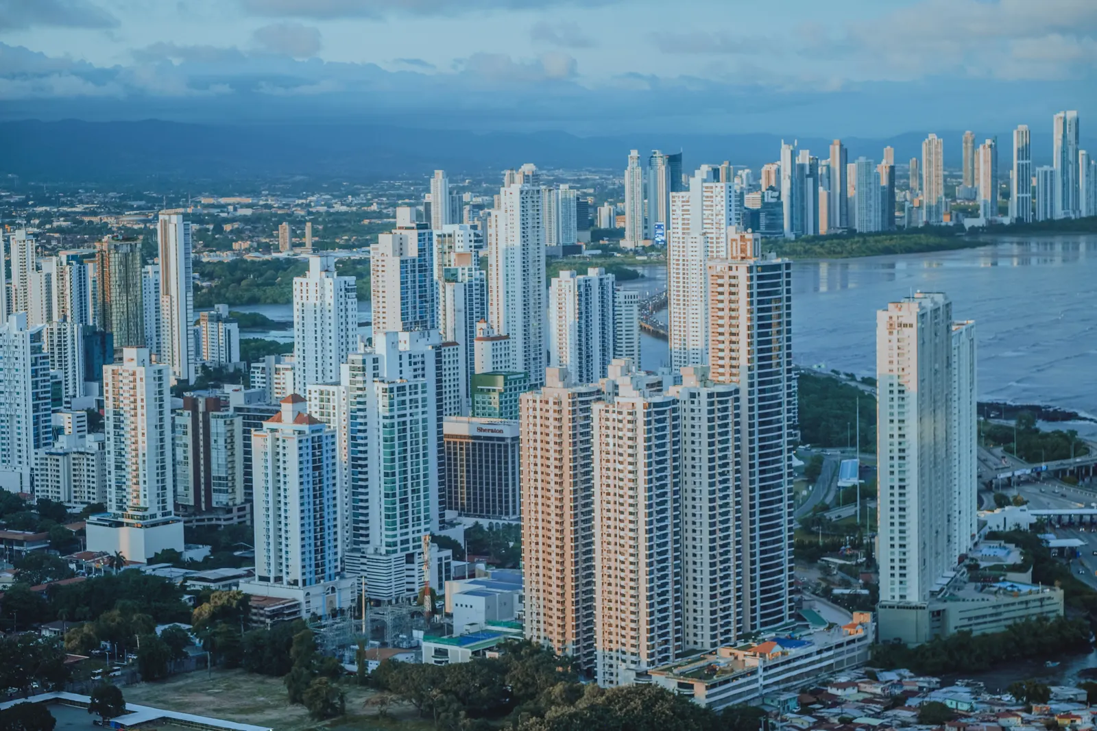 Aerial view of the Panama City skyline along the Pacific coast at dusk