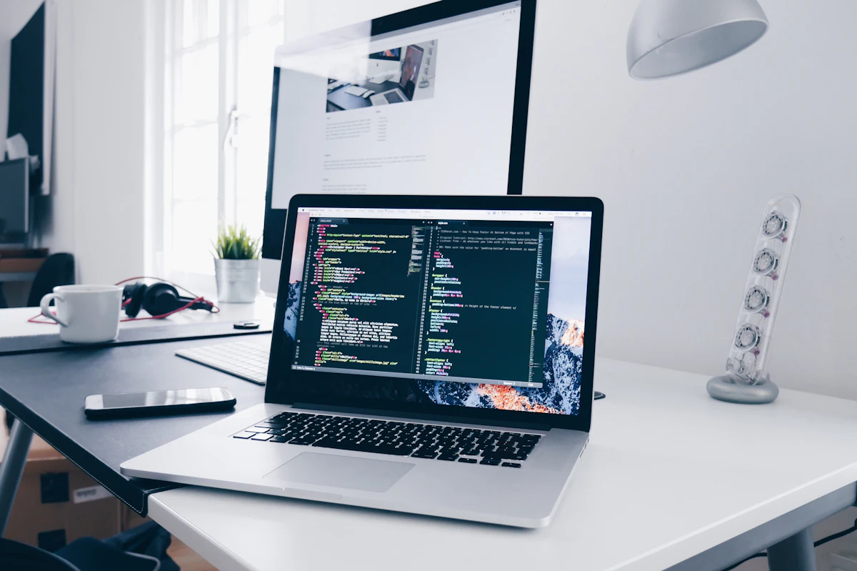 Laptop with code editor open on a bright desk